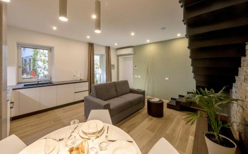 a living room with a couch and a table at Residence Casa Coppa Appartamento Duplex in Omegna