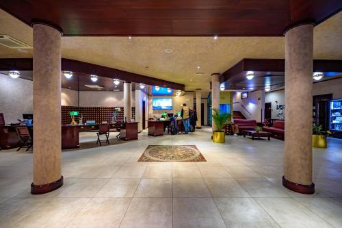 a large lobby with pillars and a lobby with a person at Boutique Hotel Nautica - SPA & wellness, FREE Parking, Pet friendly in Novigrad Istria