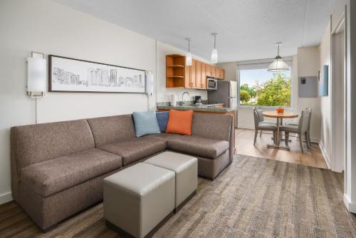 a living room with a couch and a table at Hyatt House Fort Lauderdale Airport/Cruise Port in Dania Beach