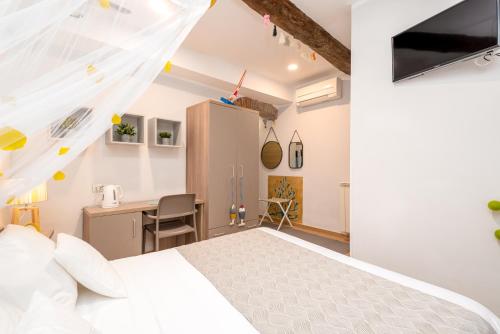 a bedroom with a white bed and a desk at Carugio Remilde in La Spezia