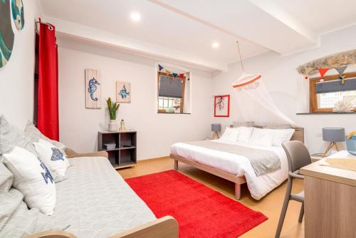 a bedroom with two beds and a red rug at Carugio Remilde in La Spezia