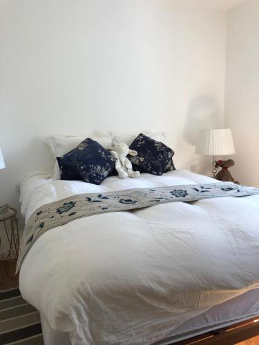 a bed with a teddy bear sitting on top of it at Villa-sleeps2-garden-private park in Camacha