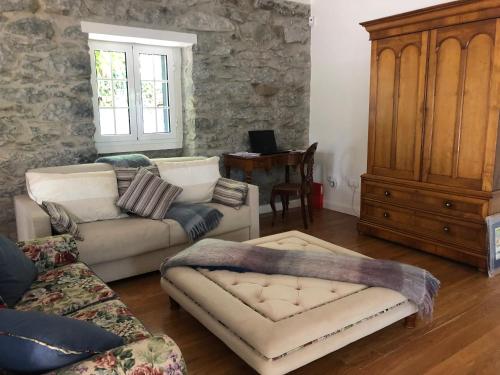 a living room with two couches and a table at Villa-sleeps2-garden-private park in Camacha