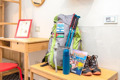 a backpack sitting on a table with a book at Carugio Remilde in La Spezia