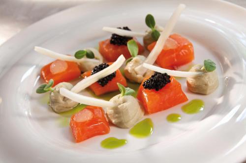 a white plate of food with vegetables on it at Benvengudo in Les Baux-de-Provence