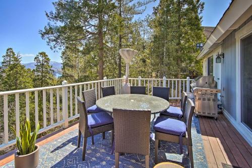 a patio with a table and chairs on a deck at Ridgeline Retreat with Mountain Lake Views! in Lake Arrowhead