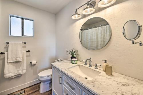 a bathroom with a sink and a toilet and a mirror at Ridgeline Retreat with Mountain Lake Views! in Lake Arrowhead