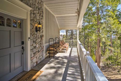 a front porch of a house with a stone wall at Ridgeline Retreat with Mountain Lake Views! in Lake Arrowhead
