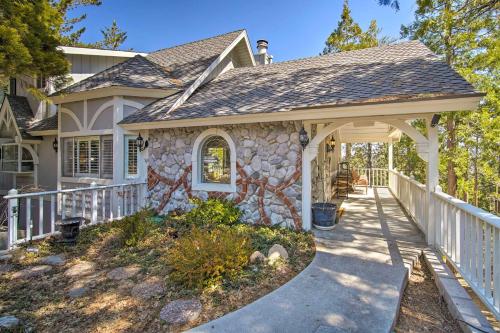 a home with a stone house with a porch at Ridgeline Retreat with Mountain Lake Views! in Lake Arrowhead