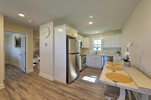 a kitchen with a table and a stainless steel refrigerator at Welcoming Wildwood Condo about 1 Block to Beach! in Wildwood