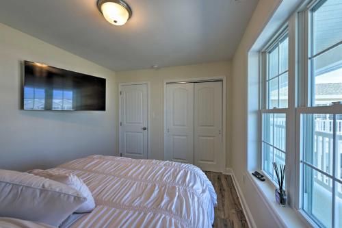 a bedroom with a bed and a large window at Welcoming Wildwood Condo about 1 Block to Beach! in Wildwood