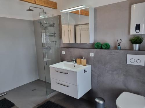 a bathroom with a white sink and a shower at Ferienwohnung Emely in Mechernich