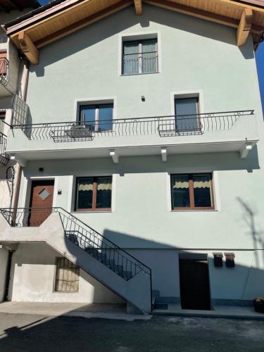 a white building with stairs in front of it at Casa Carral in Aymavilles