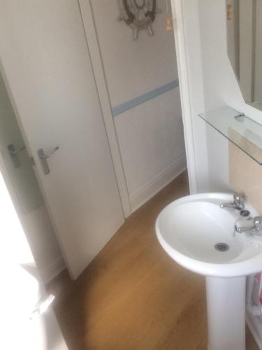 a bathroom with a white sink and a toilet at Lovely little flat by the sea in Cleethorpes in Cleethorpes