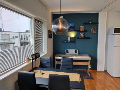 a room with a table and a kitchen with a window at Top floor apartment with a magic view in Tromsø