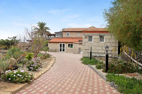 a brick walkway in front of a house at Casa Munay in Granadilla de Abona