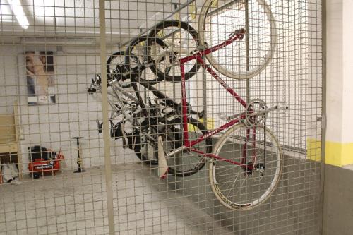 a red bike is hanging on a wall at Hotel Toresela Bike am Gardasee in Nago-Torbole