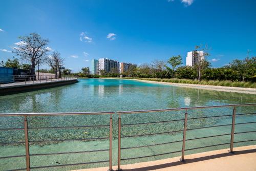 a body of water with buildings in the background at 87978 DELUXE and unique 3BR condo by The Harbor, Via Montejo in Mérida