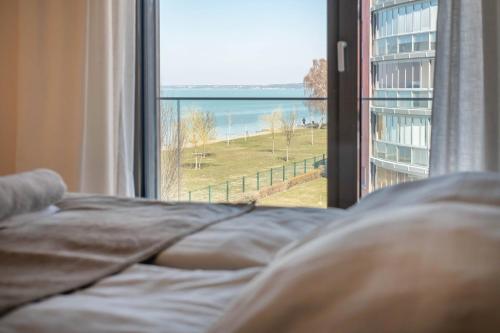 A bed or beds in a room at MyFlat Coral Beach Apartment