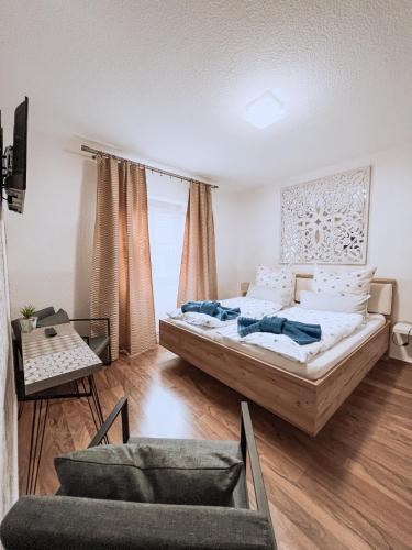 a bedroom with a large bed and a couch at Landhotel "Schwarzach am Main" in Schwarzach am Main