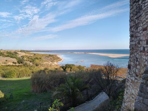 a view of the ocean from a castle at Casinha Secreta - A Gema Escondida da Santa Luzia in Santa Luzia