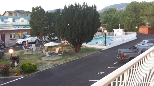 a view from a balcony of a parking lot with a pool at Swiss Sunset Inn in Penticton