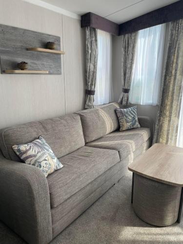 a living room with a couch and a table at Swift Bordeaux 67 in Dunoon