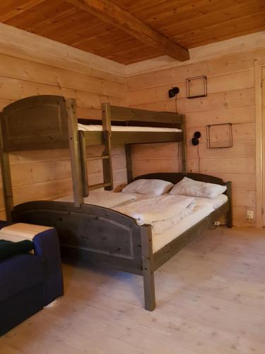 a bedroom with two bunk beds in a cabin at Rongen gard in Bolstadøyri