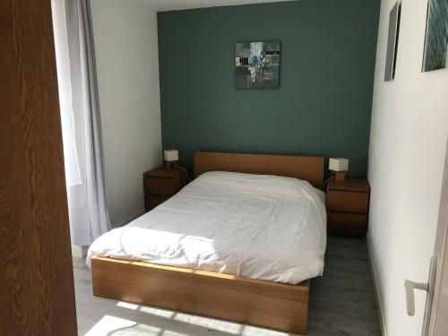 a small bedroom with a bed with two night stands at Gite de kermoel, Hoedic in Kernascléden