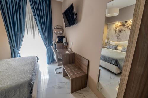 a bedroom with two beds and a mirror at Eolian Port B&B in Milazzo