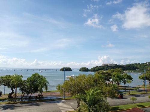 a view of a large body of water with a bridge at Indy's Best Bay FrontView in Samana. in Santa Bárbara de Samaná
