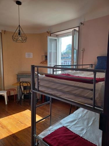 a bedroom with a bed and a window at Gite Compostella in Saint-Jean-Pied-de-Port