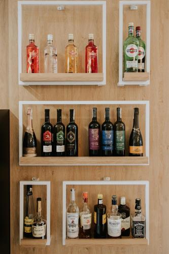 a shelf filled with lots of bottles of alcohol at Hotel Dębowe Wzgórze Wellness & Spa in Jarnołtówek
