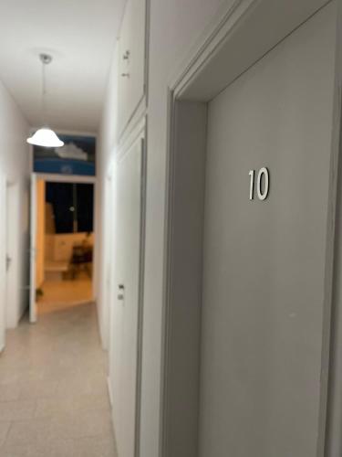 a hallway with a door with the number on it at Cal Day Rooms Santorini in Perissa