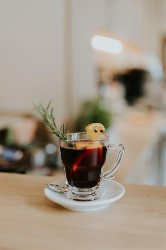 a cup of coffee sitting on a table at Hotel Dębowe Wzgórze Wellness & Spa in Jarnołtówek