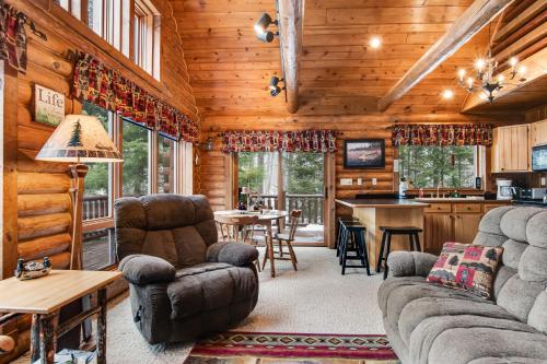 a living room with a couch and chairs in a cabin at Annabelle Log Home in Presque Isle