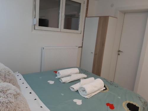 two towels sitting on a bed in a room at Apartman Živković in Leskovac