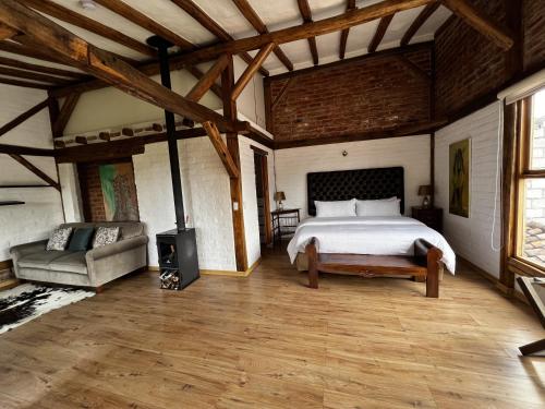 a bedroom with a bed and a fireplace in it at Hacienda Jimenita Wildlife Reserve in Puembo