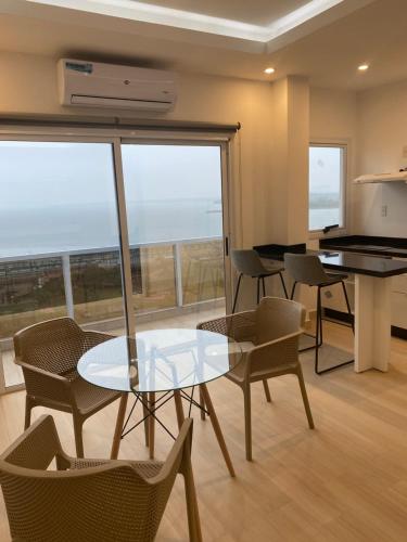 a dining room with a glass table and chairs at 25 homeApart in Encarnación