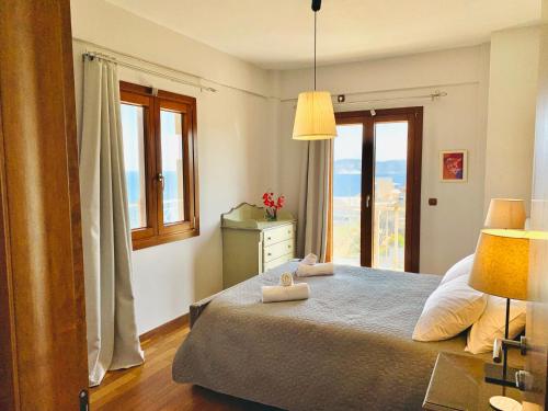 a bedroom with a bed with two towels on it at Villa Kalli - Porto Ennia in Vromopoúsi