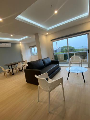 a living room with a couch and a table at 25 homeApart in Encarnación