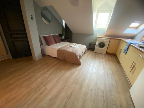a bedroom with a bed and a wooden floor at Mon Petit Orne Centre thermal Un-Séjour-à-Part in Rombas