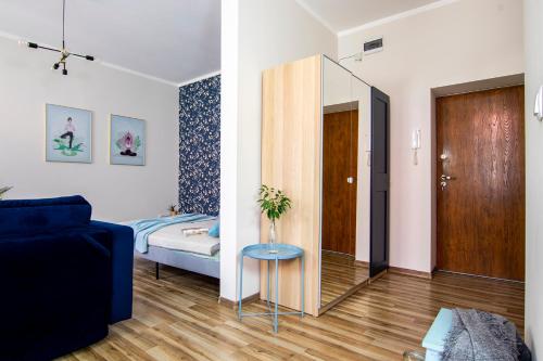 a living room with a bed and a glass table at Apartamenty KDN in Bielsko-Biała