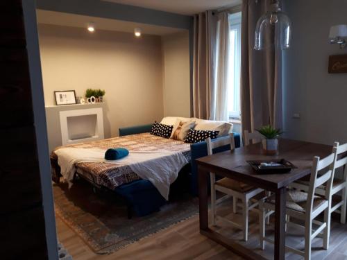 a bedroom with a bed and a table and chairs at Magnolia@27 Lake Iseo in Sarnico