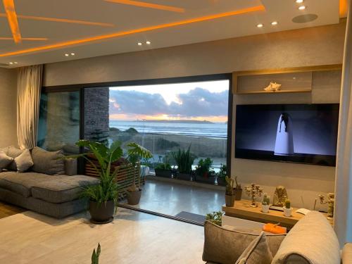 a large living room with a large screen television at PRESTIGIA ESSAOUIRA MOGADOR Luxury Ocean View in Essaouira