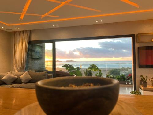 a bowl on a table in a living room with a view at PRESTIGIA ESSAOUIRA MOGADOR Luxury Ocean View in Essaouira