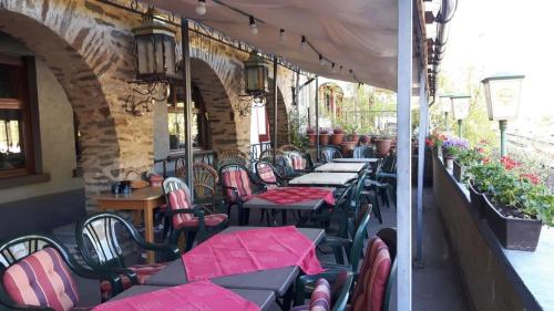 a row of tables and chairs on a patio at Kranenturm hotel in Bacharach
