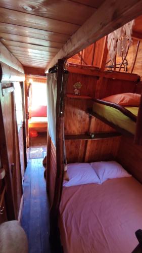 a small bedroom with a bed in a boat at Luna treehouse in Preveza