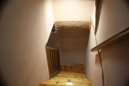 a view of a stairway with a wooden railing at Casita La Glorieta in Peñafiel