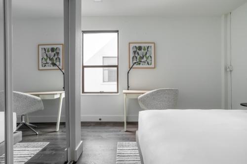 a white room with a table and chairs and a window at Reside Seattle Downtown, a Wyndham Residence in Seattle
